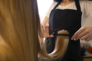 female-client-getting-her-hair-cut-hairdresser
